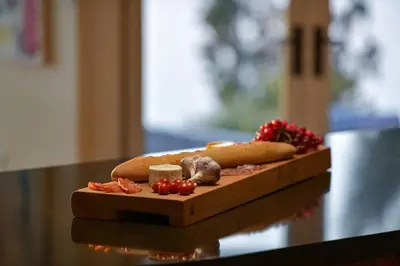 a cutting board with food on top of a table at Island Luxury Oceanside Estate by EMR Vacation Rentals in Saanichton