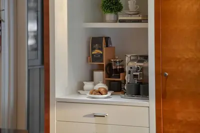 a shelf with a coffee maker and a plate of pastries at Island Luxury Oceanside Estate by EMR Vacation Rentals in Saanichton