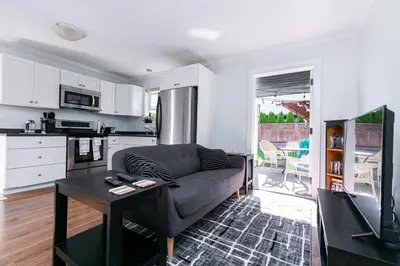 a living room with a couch and a table at Great 1-bedroom Suite Near Downtown Langford in Victoria
