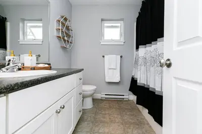 a white bathroom with a sink and a toilet at Great 1-bedroom Suite Near Downtown Langford in Victoria