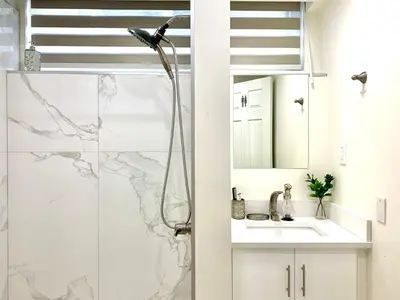 a bathroom with a shower and a sink at 3Beds 2BA Cherry Blossom Suite - Free Parking - Central Oakridge Neighbourhood in Vancouver