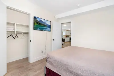a bedroom with a bed and a tv on the wall at William Place in Surrey