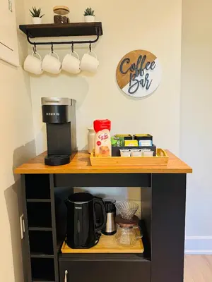 a coffee station with a coffee maker on a shelf at Creek Side 2-Bedroom Guest Suite in Burnaby