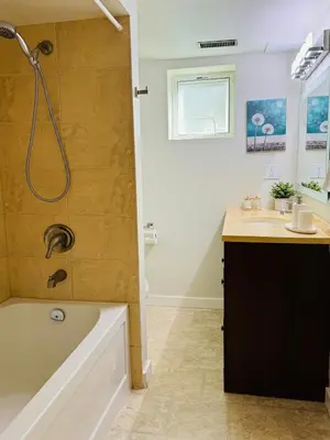 a bathroom with a tub and a sink at Creek Side 2-Bedroom Guest Suite in Burnaby