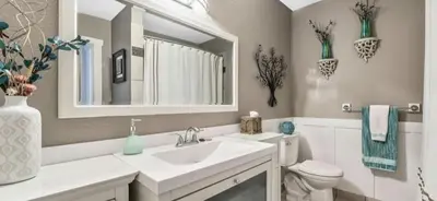 a bathroom with a sink and a toilet and a mirror at hunter' s new home! in Calgary