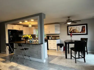a kitchen with a table and chairs in a room at hunter' s new home! in Calgary