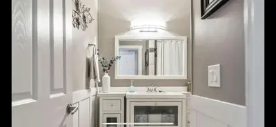 a bathroom with a white sink and a mirror at hunter' s new home! in Calgary
