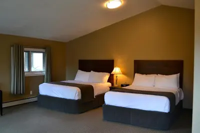 a hotel room with two beds and a window at A Good Nite's Rest Bed and Breakfast in Banff