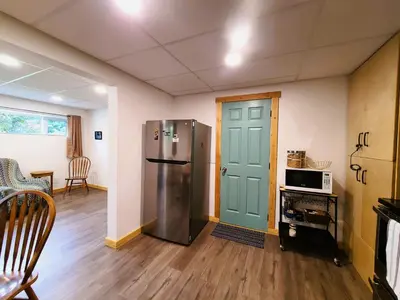 a kitchen with a stainless steel refrigerator and a microwave at Woodcrest Bed and Breakfast in Clearwater