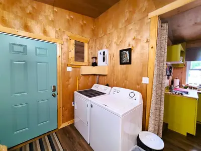 a washer and dryer in a kitchen with a door at Woodcrest Bed and Breakfast in Clearwater