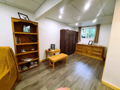 a room with a bed and a table and a window at Woodcrest Bed and Breakfast in Clearwater