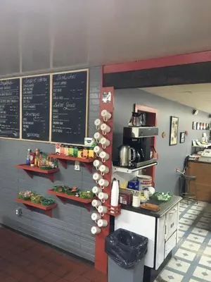 a kitchen with a counter and a chalk board at Double G Service in Muncho Lake