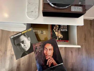 a shelf with two movieazines and a book on it at The Evergreen House in Red Deer