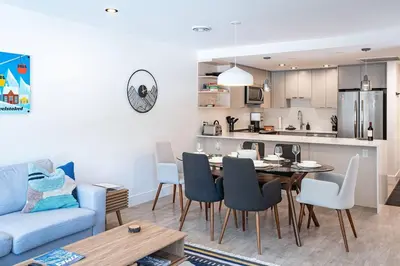 a kitchen and a living room with a table and chairs at Rocky Ridge Getaway - Modern Getaway in Revelstoke in Revelstoke