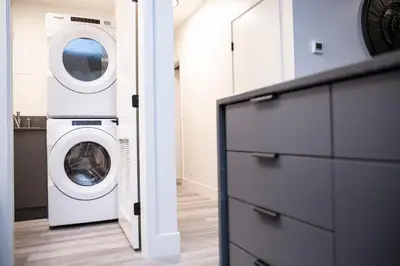 a laundry room with a washer and a dryer at Selkirk Staytion - Stylish Condo with Hot Tub in Revelstoke