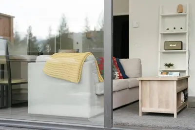 a living room with a couch and a table at The Nest - Condo with Hot Tub & BBQ in Revelstoke