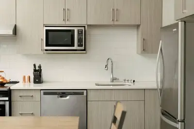 a kitchen with a sink and a microwave at The Nest - Condo with Hot Tub & BBQ in Revelstoke