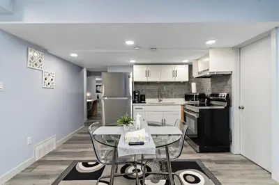 a kitchen with a table and chairs in a room at The Cozy Cove - Modern Private Basement Suite with Comfort & Charm, Free Parking, WiFi, Netflix Close to airport & 18 minutes to West Edmonton Mall in Edmonton