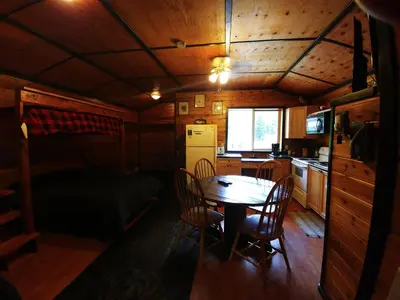 a dining room with a table and chairs in a cabin at Bone Creek Wilderness Retreat in Blue River