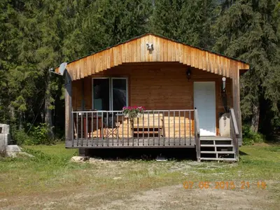 a small cabin with a porch and a door at Bone Creek Wilderness Retreat in Blue River