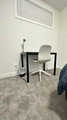 a desk and a chair in a room at The Cozy Nest in Calgary