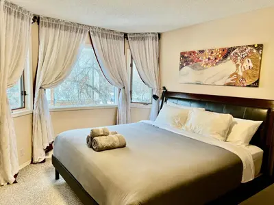 a bedroom with a bed with a stuffed animal on it at Crescent Heights Majesty in Calgary