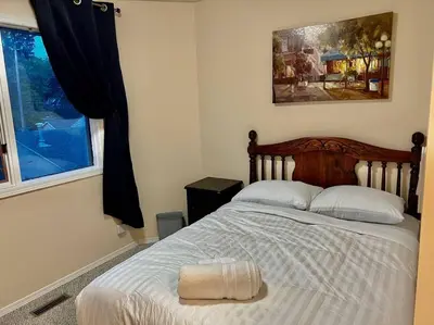 a bedroom with a bed with a pillow on it at Crescent Heights Majesty in Calgary