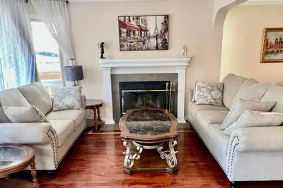 a living room with two couches and a fireplace at Crescent Heights Majesty in Calgary