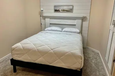 a small bedroom with a bed with two pillows at Crescent Heights Majesty in Calgary