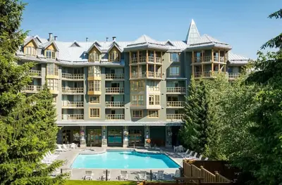 a large apartment building with a large swimming pool at Renovated 1Bed-1Bath in Village with Pool, Hot Tub, and Sauna in Whistler