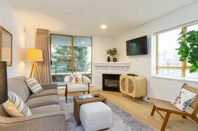 a living room with a couch and a fireplace at Renovated 2Bed-2Bath in Village with Pool, Hot Tub, and Sauna in Whistler