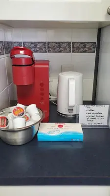 a kitchen counter with a coffee maker and a mixing bowl at 12 Spacious Home W Ac, Crib, Garage, By Airport in Calgary