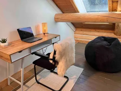 a dog sitting on a chair next to a desk at Golden Cabin - Hot Tub - Games Barn - Theatre in Golden