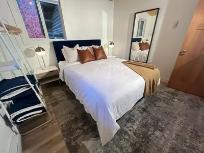 a bedroom with a large white bed and a ladder at Golden Cabin - Hot Tub - Games Barn - Theatre in Golden