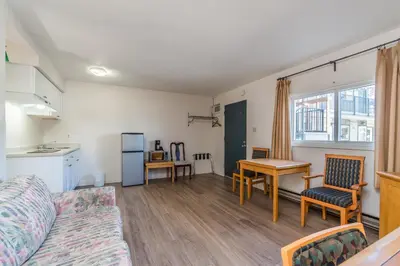 a living room with a couch and a table at Bluebird Motel in Nanaimo