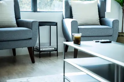 a living room with two chairs and a coffee table at Ski & Tee Retreat Bright Three Bedroom and Hot Tub in Revelstoke