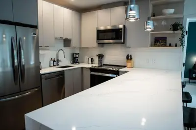a kitchen with white counters and stainless steel appliances at Ski & Tee Retreat Bright Three Bedroom and Hot Tub in Revelstoke