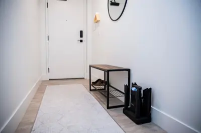 a hallway with a table next to a door at Ski & Tee Retreat Bright Three Bedroom and Hot Tub in Revelstoke