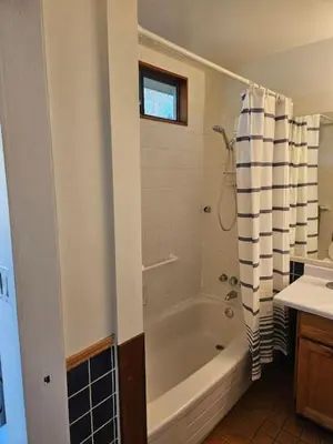 a bathroom with a bath tub and a sink at Pebbly Beach Suite in Snug Cove in Bowen Island