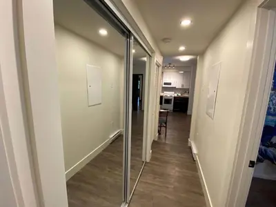 a hallway with a glass door leading to a kitchen at Calming 1bedroom Units With Balcony And City View in Edmonton