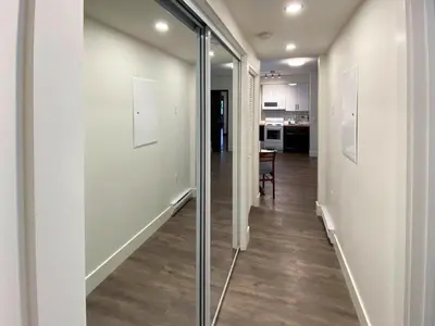 a hallway with glass doors and a dining room at Calming 1bedroom Units With Balcony And City View in Edmonton