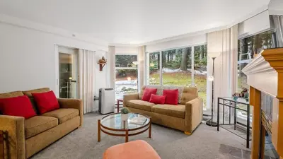 a living room with two couches and a table at Woodrun Lodge 214 | Ski-in-Ski-Out Condo, Heated Pool, Hot Tub, Gym in Whistler