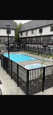 a swimming pool in front of a building at Brand New 2BR Condo with Outdoor Swimming Pool and Hot Tub in Canmore