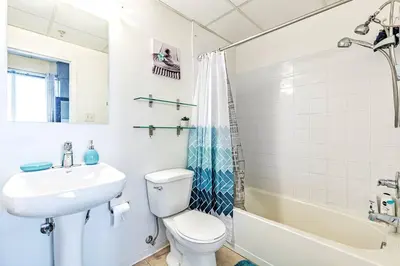 a bathroom with a sink and a toilet and a tub at Industrial-Style Cityscape 1 Bedroom Loft in Edmonton