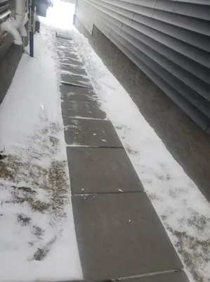 a sidewalk covered in snow next to a building at Deluxe 2 bedroom suite with*Netflix/Cable/Prime in Edmonton