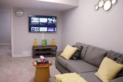 a living room with a couch and a flat screen tv at Deluxe 2 bedroom suite with*Netflix/Cable/Prime in Edmonton