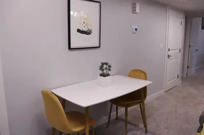 a dining room with a white table and chairs at Deluxe 2 bedroom suite with*Netflix/Cable/Prime in Edmonton