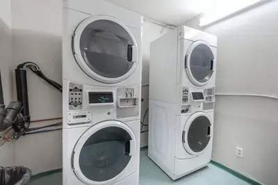 two washing machines sitting next to each other in a room at Casa Creekside - Walk to Gondola, Shops, lakes! in Whistler