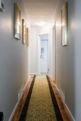a hallway with white walls and a rug on the floor at NorthVAN nature living home in North Vancouver