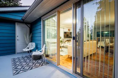 a sliding glass door on a house with a patio at NorthVAN nature living home in North Vancouver